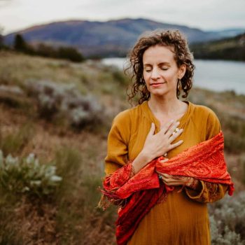 pexels-photo-28978128-28978128 Woman in serene meditation near a lake, embracing wellness and peace.